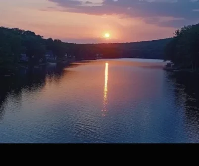 a serene sunset over a picturesque lake in watertown, ct.