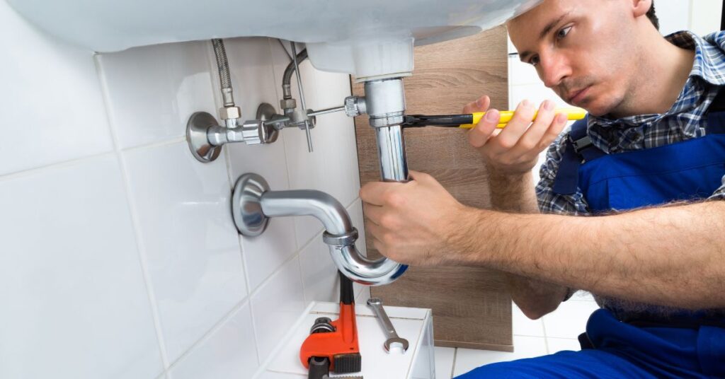 goshen plumber working on sink