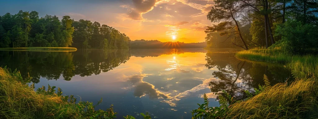a breathtaking sunrise casts golden rays over a tranquil lake, reflecting the vibrant hues of the sky and surrounded by lush, verdant forests.