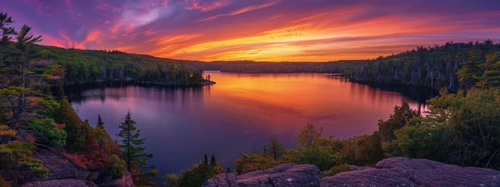 a breathtaking sunset paints the sky in vibrant oranges and purples, casting a warm glow over a tranquil lake surrounded by lush, emerald-green forests.
