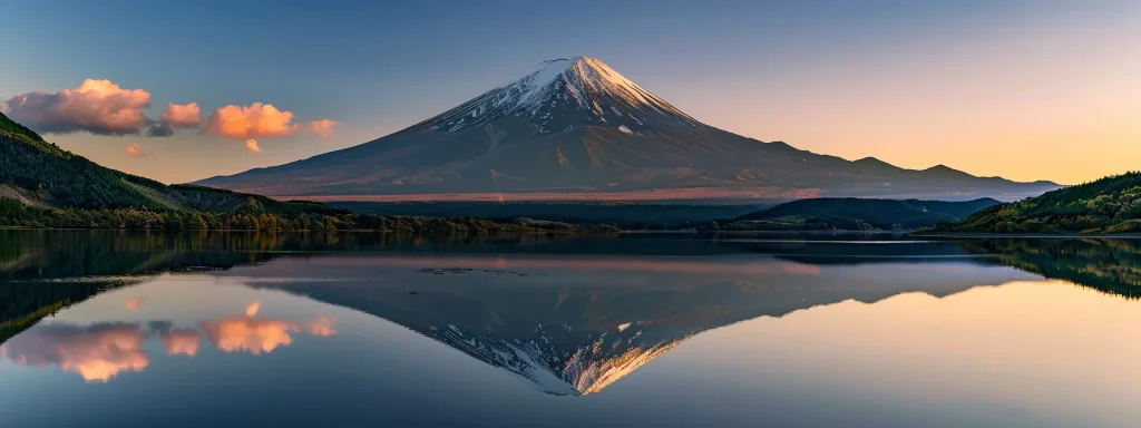 a majestic mountain peak towers above a serene lake at dawn, reflecting the vibrant hues of the rising sun against a backdrop of clear blue skies.