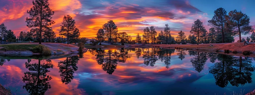 a vibrant sunset casts a golden glow over a serene lake, reflecting the silhouettes of towering pine trees against the colorful sky.